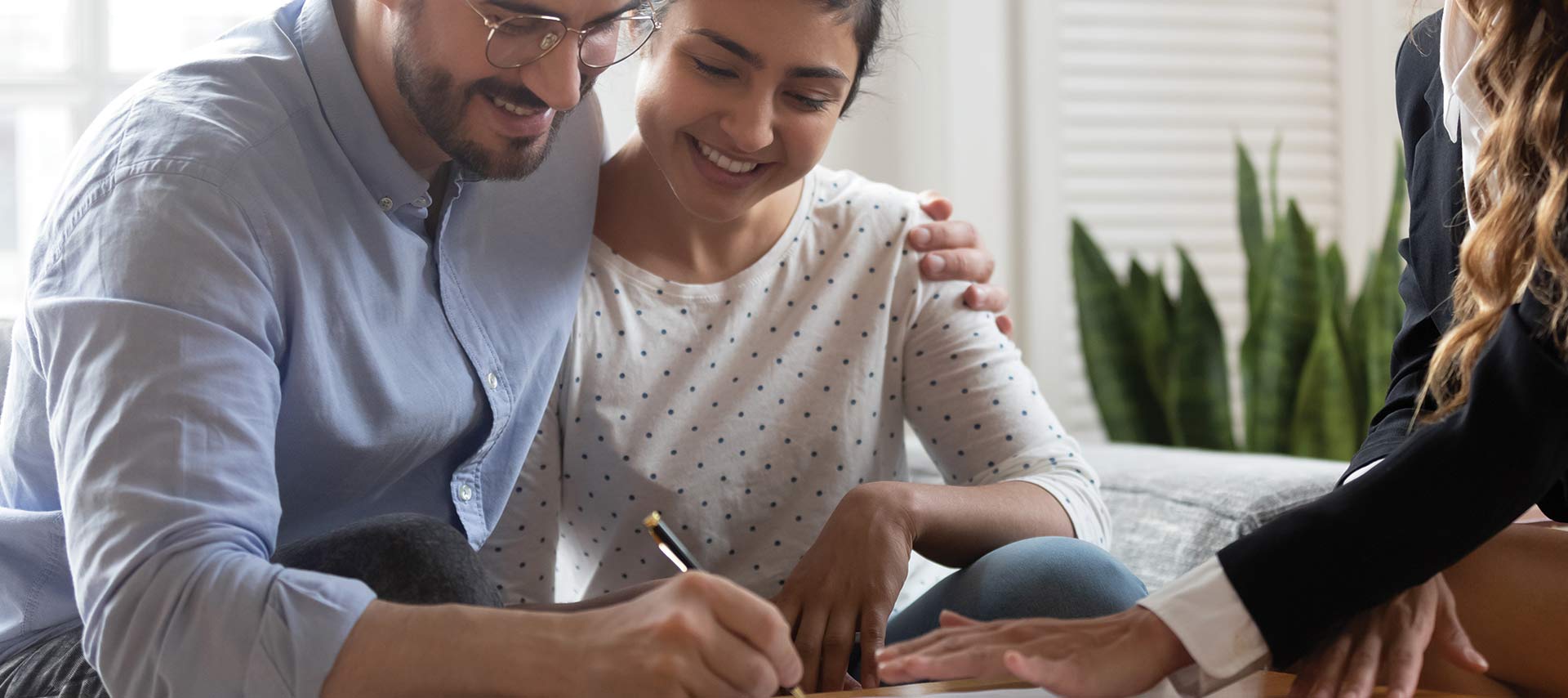 Insurance Agent helping a couple sign up for insurance